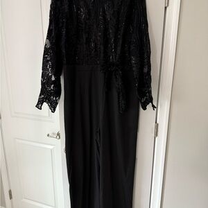Black pant suit with sequined and lace top. Brand new.